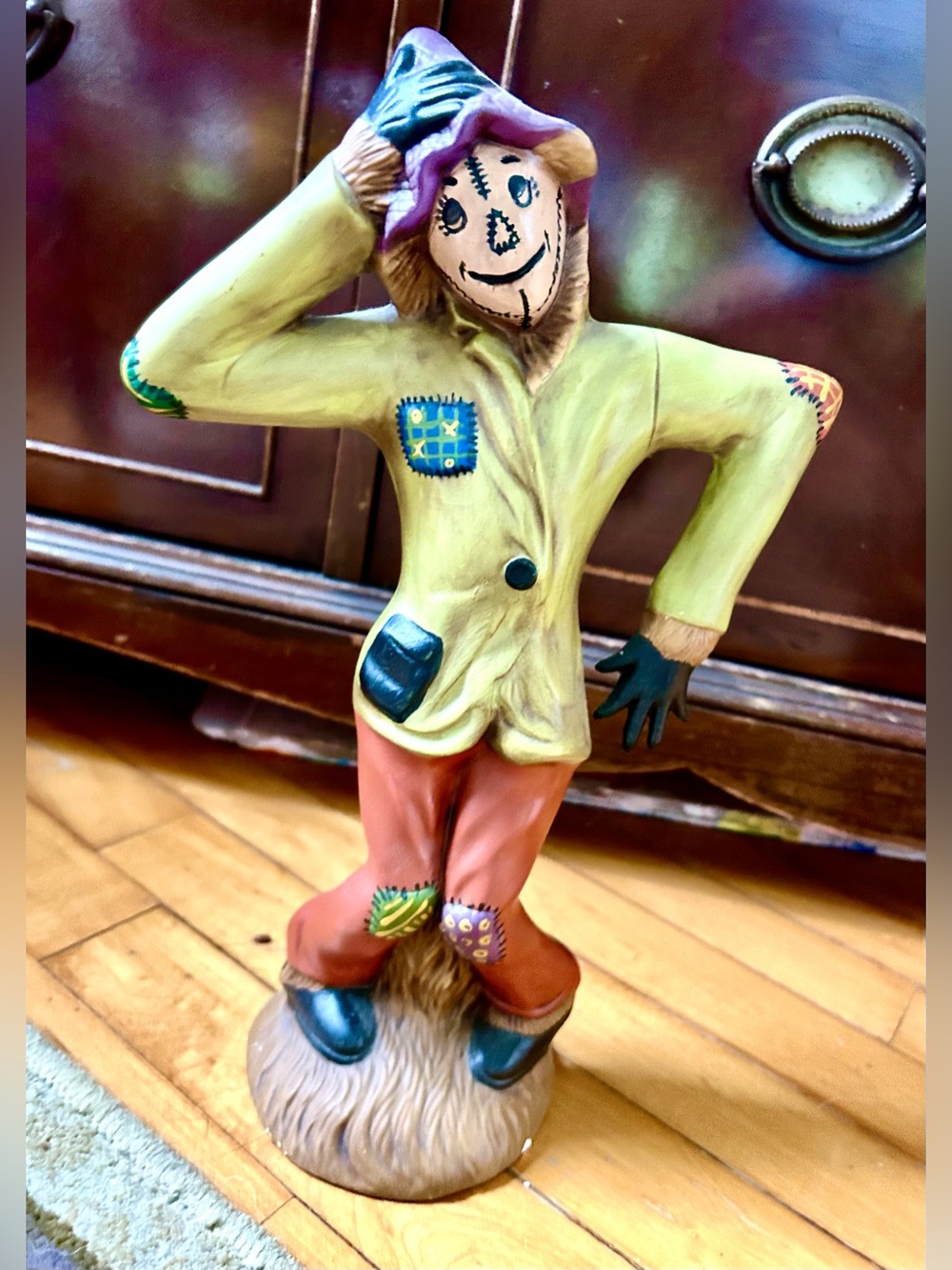 Whimsical Scarecrow Figurine in Yellow Jacket & Rust Pants with Purple Hat.
